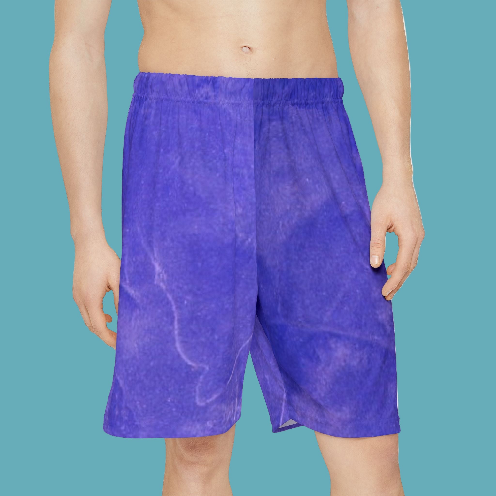 Blue shorts worn by a person on a white background