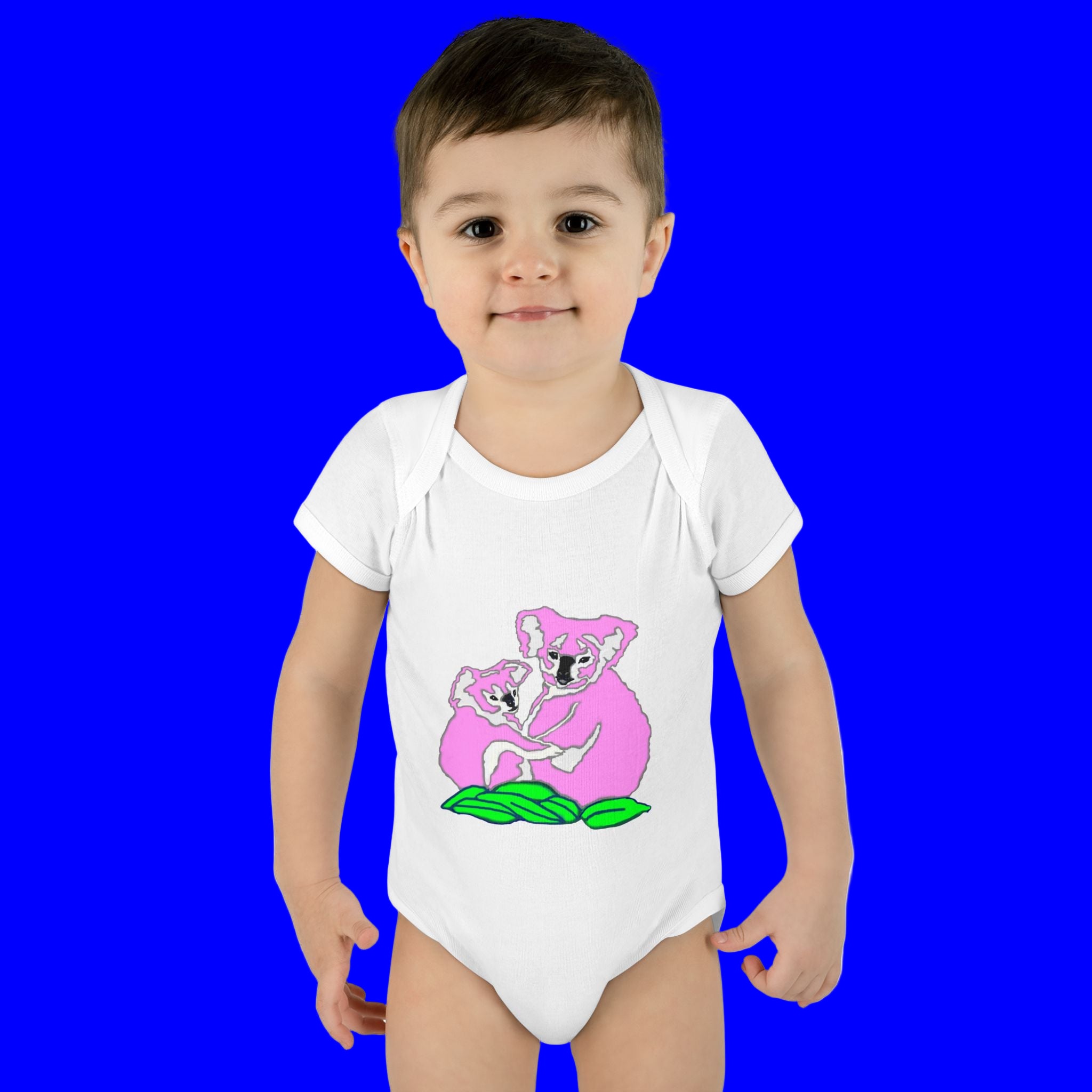 Child wearing a white onesie with a pink koala design on a white background