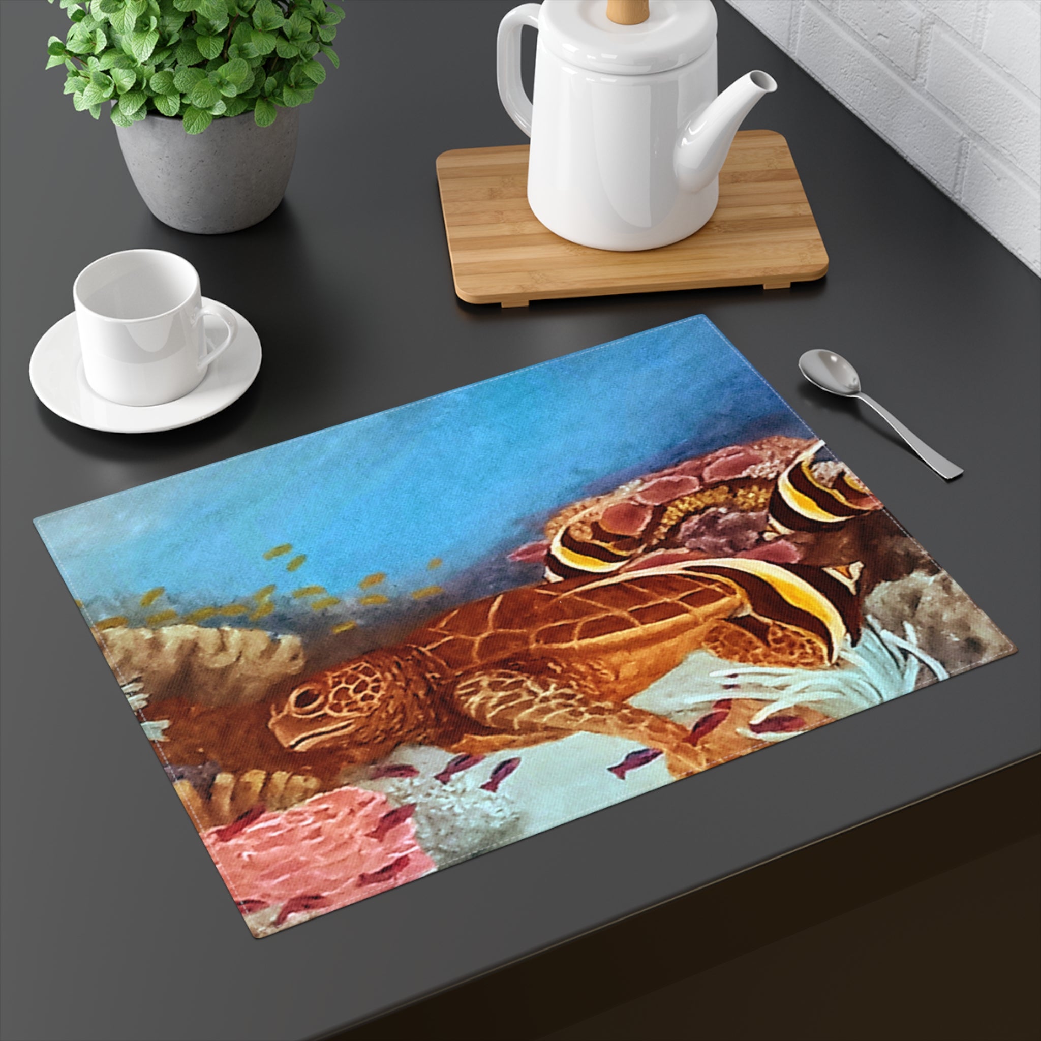 Placemat with turtle design on a dark surface with tea set