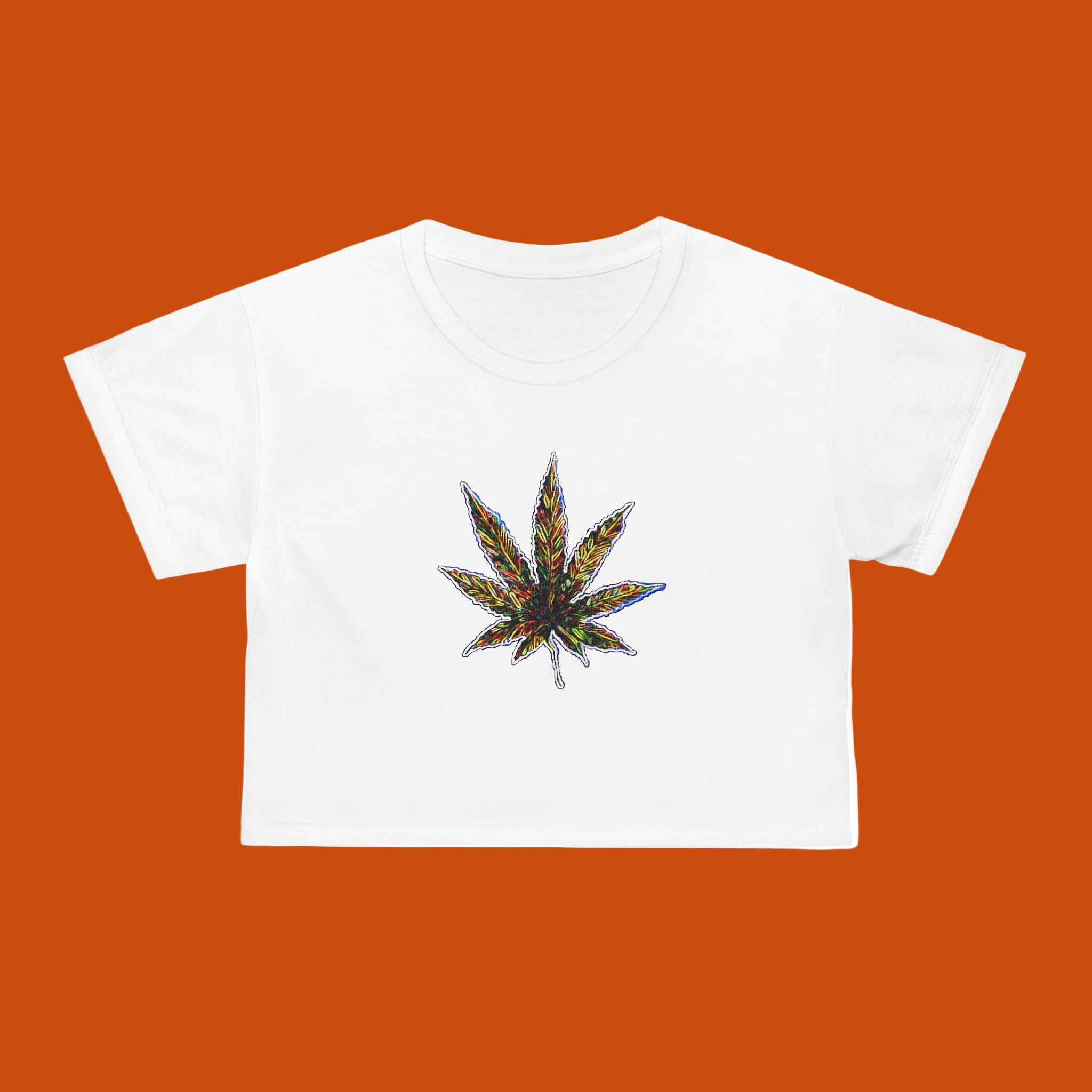 White crop T-shirt with a colorful cannabis leaf design on an orange background