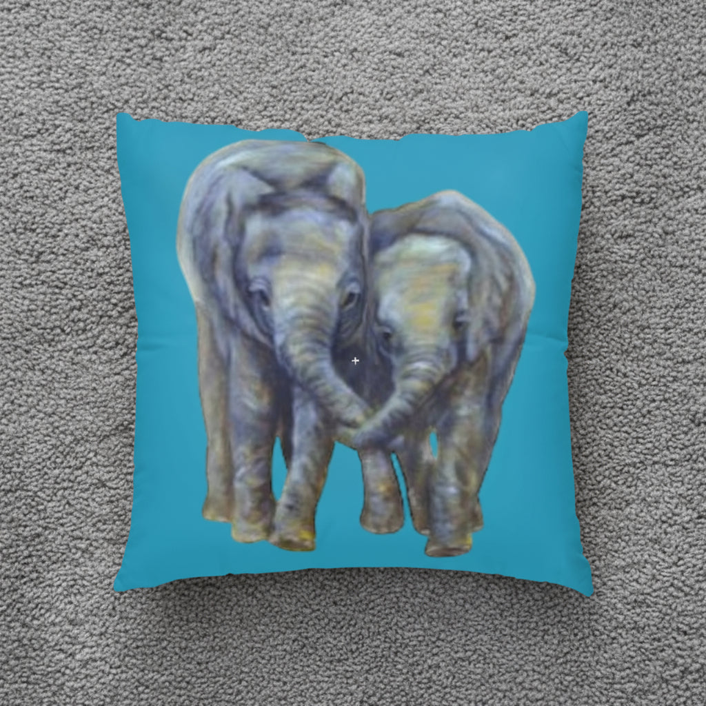 Pillow with an elephant design on a teal background