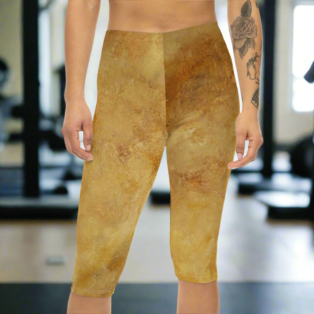 woman standing in capri abstract leggings in a gym