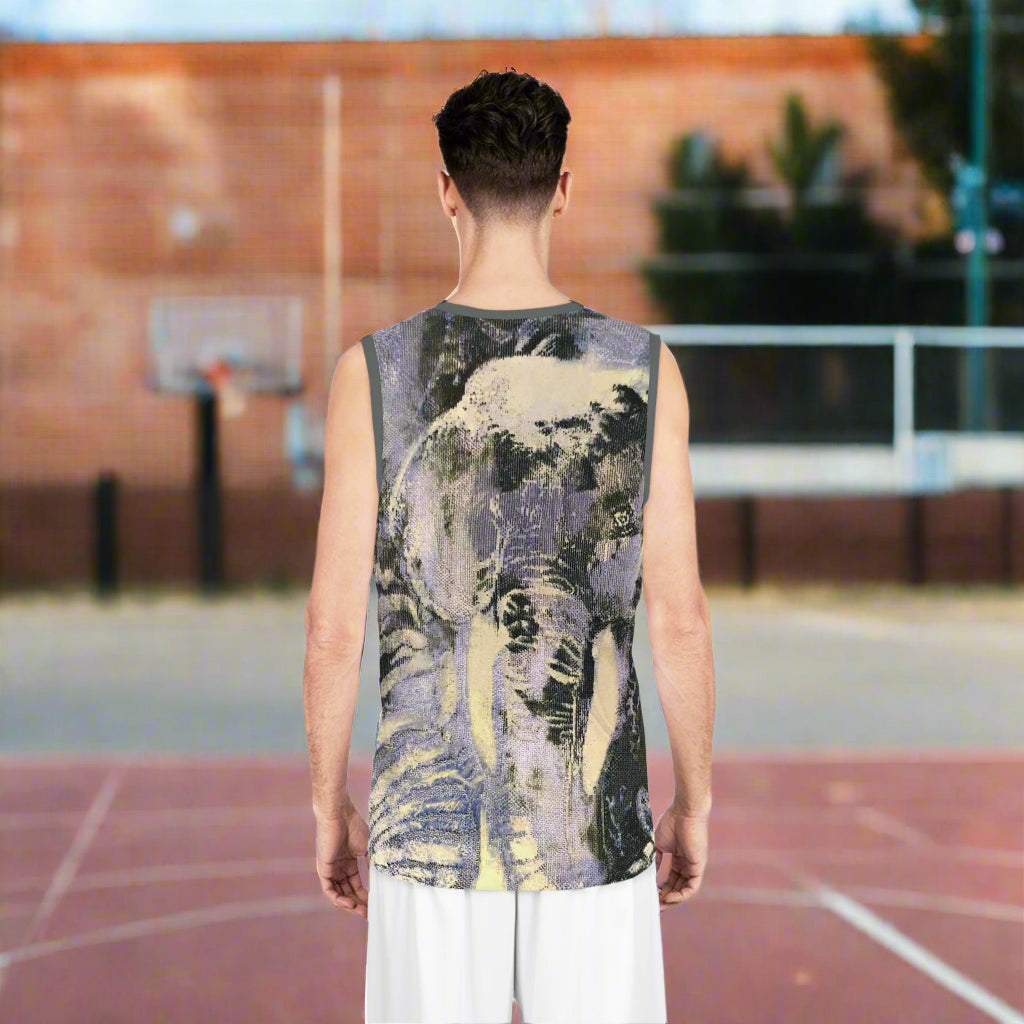 Person wearing a sleeveless shirt with an elephant design on the back, standing against in a basketball court background
