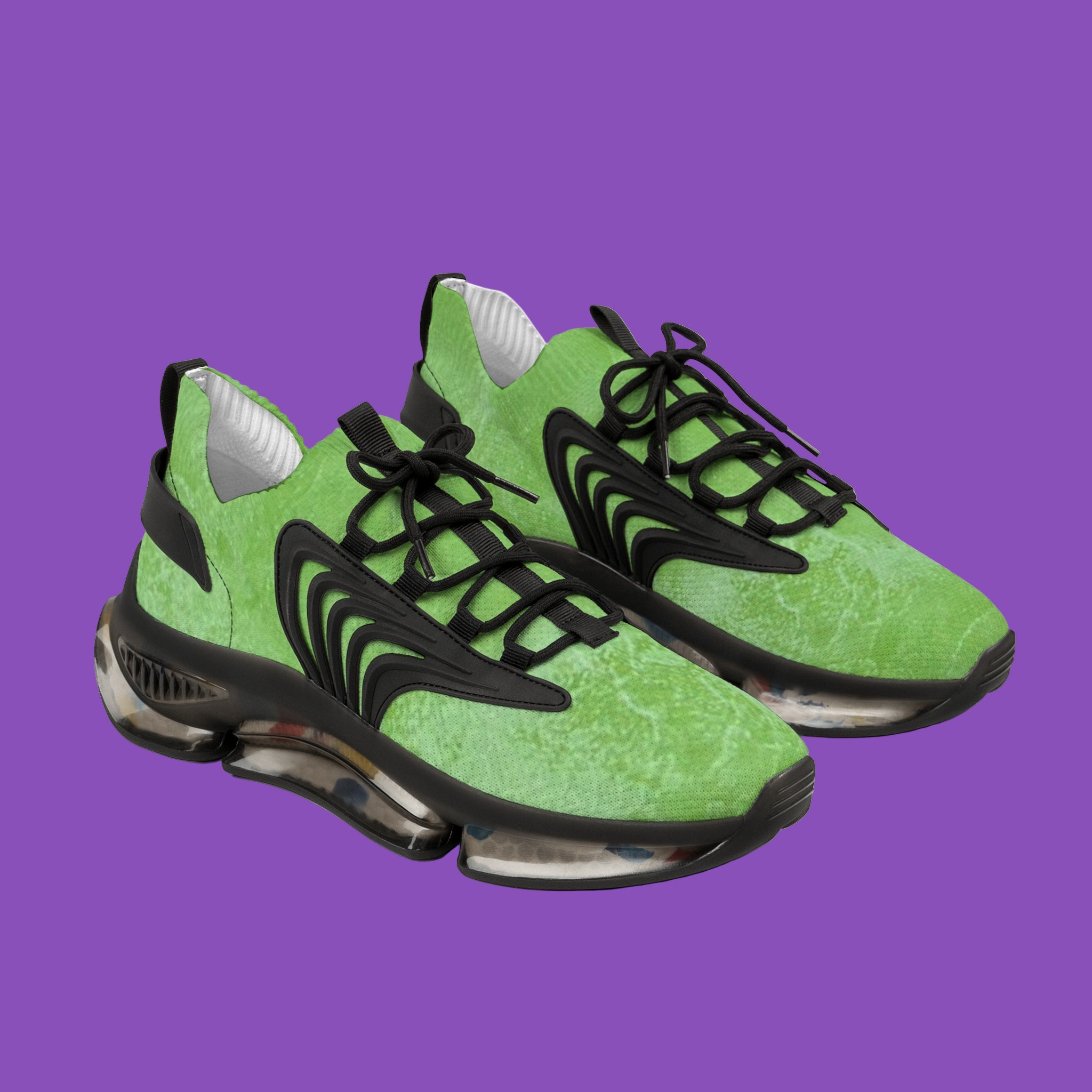 Green sneakers with black accents on a white background