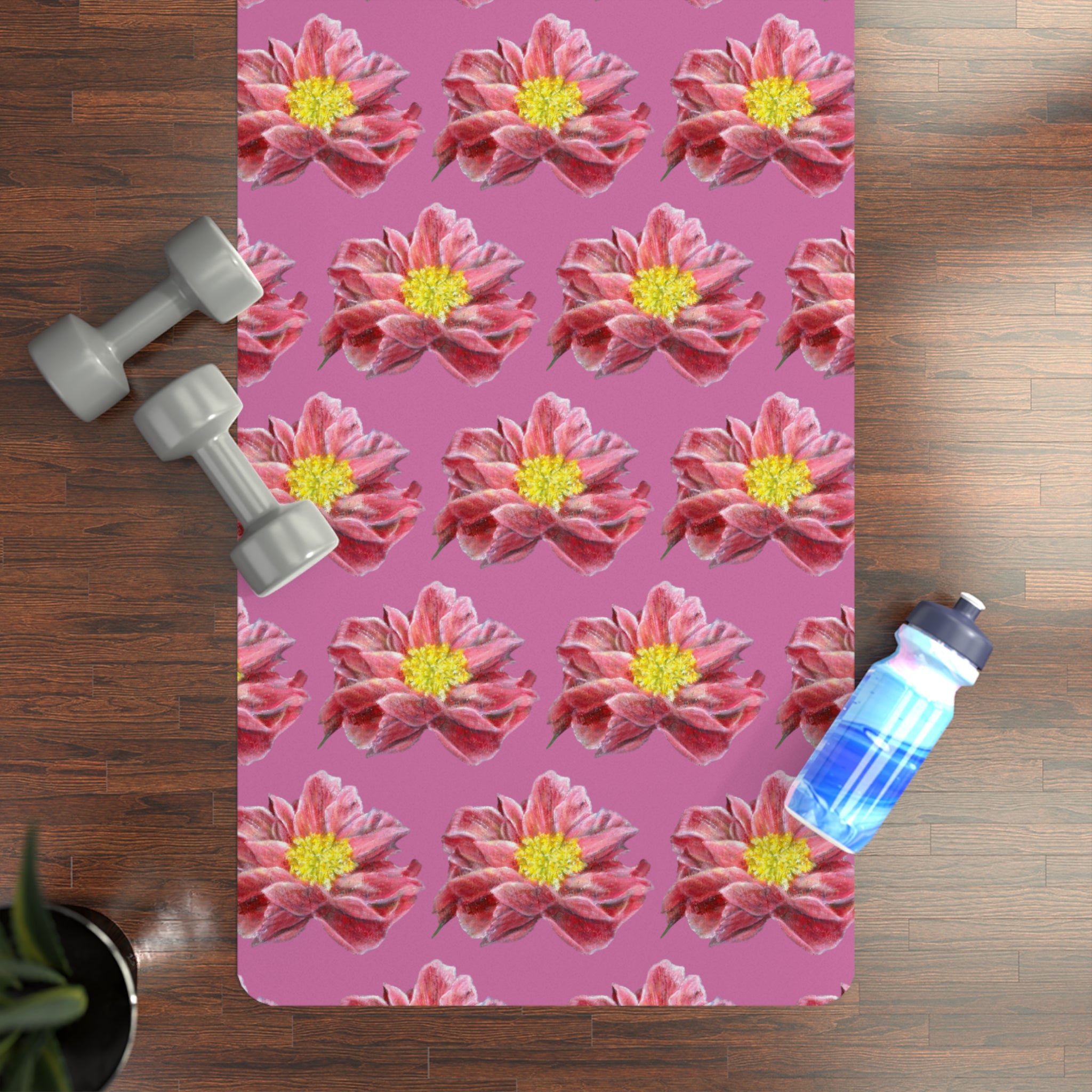 Floral-patterned mat on a wooden floor with dumbbells and a water bottle.