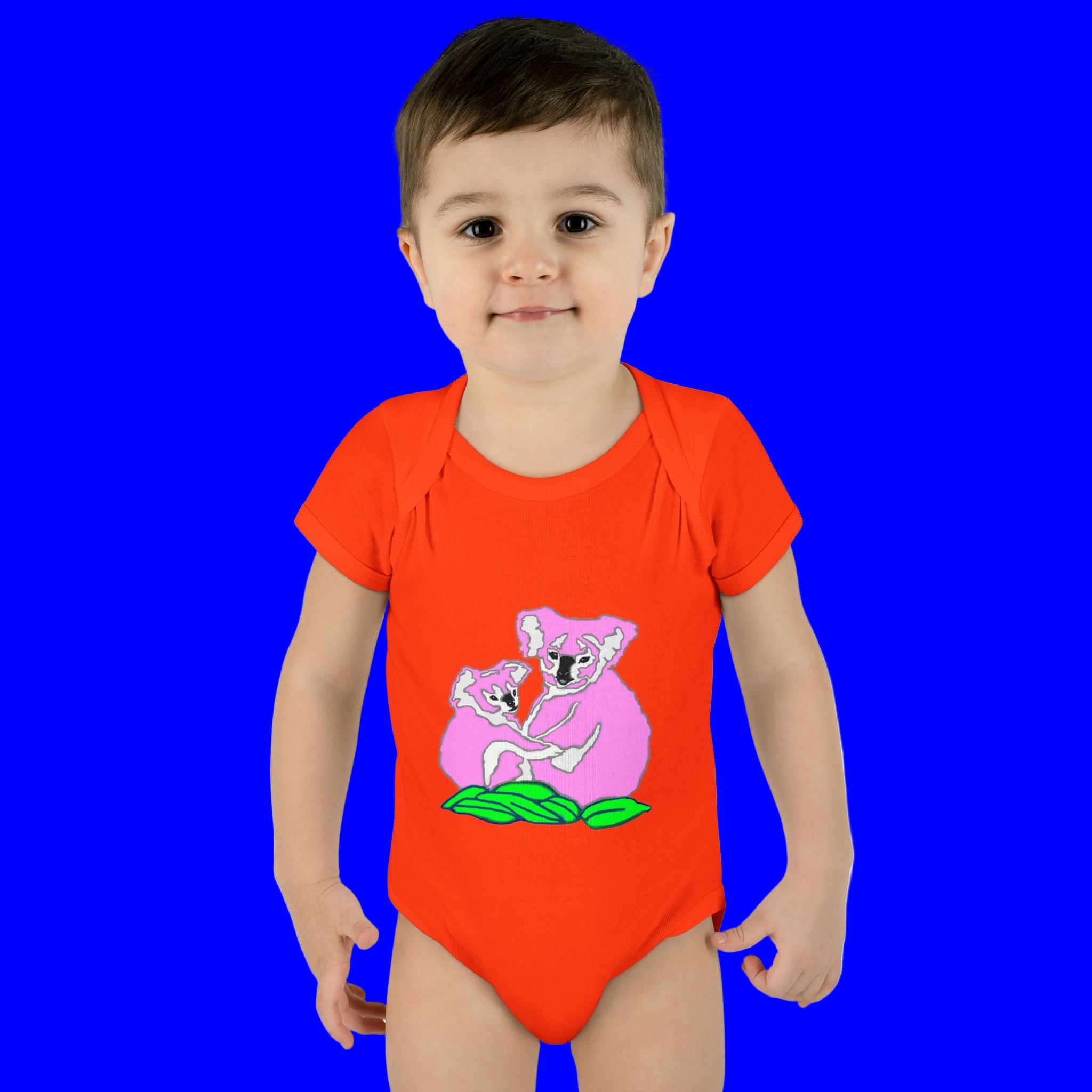 Child wearing a red onesie with a koala design on a white background