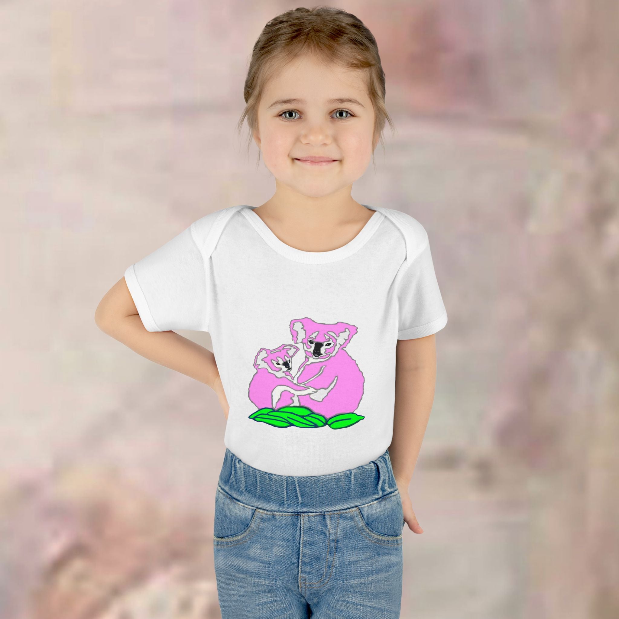 Child wearing a white t-shirt with a pink koala design on a blurred background