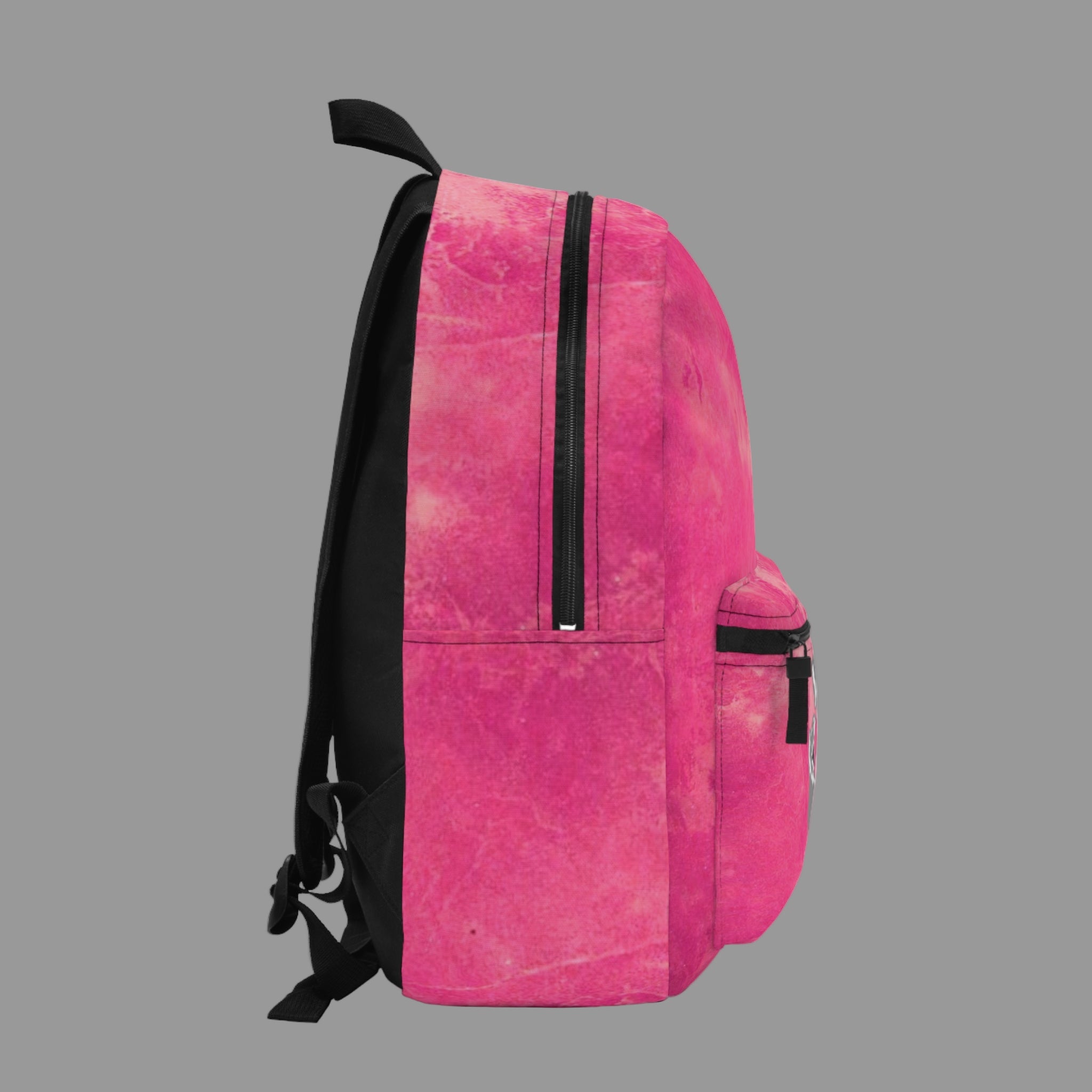 Pink backpack with black zippers on a light gray background