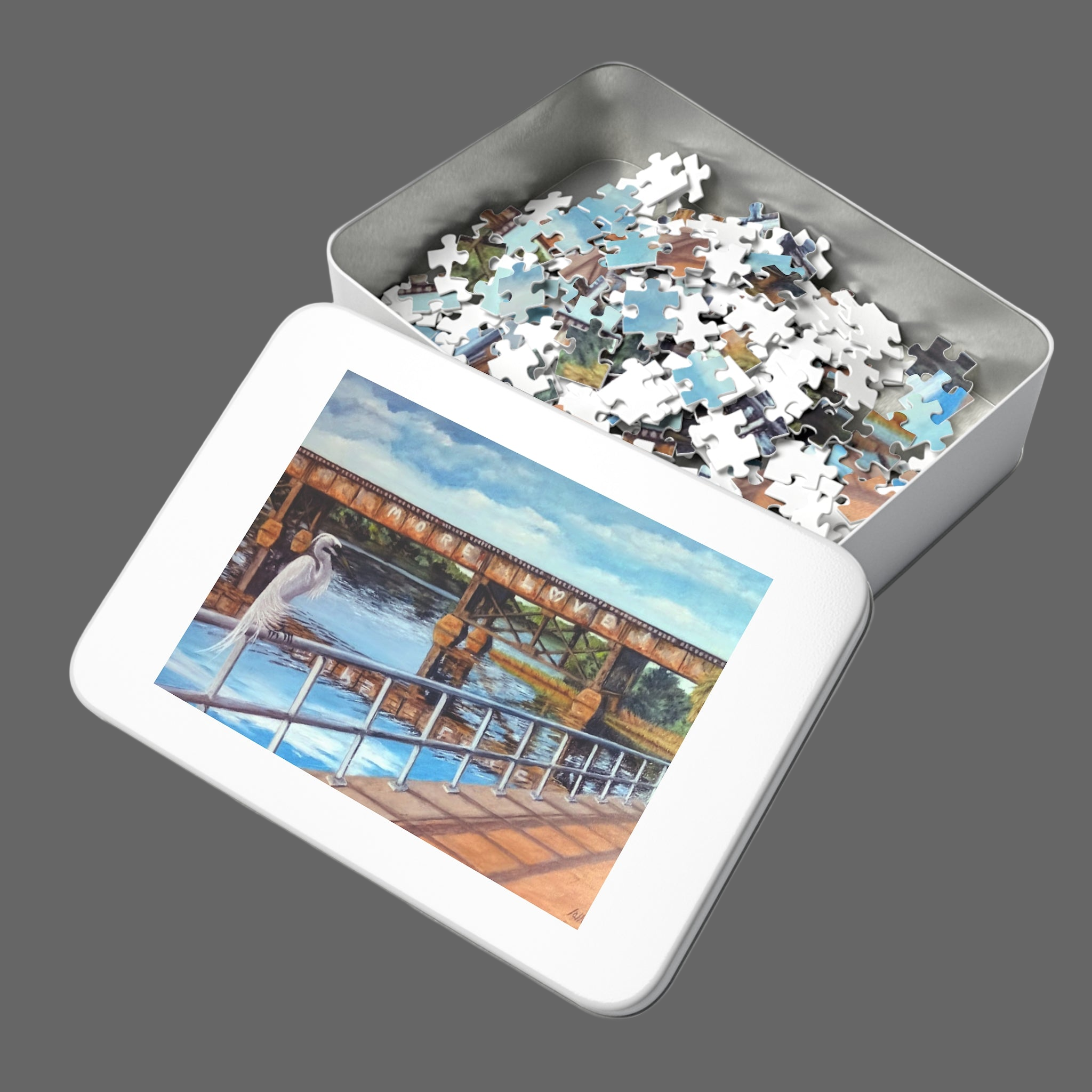 Jigsaw puzzle in a metal tin with a picture of a bridge on the lid