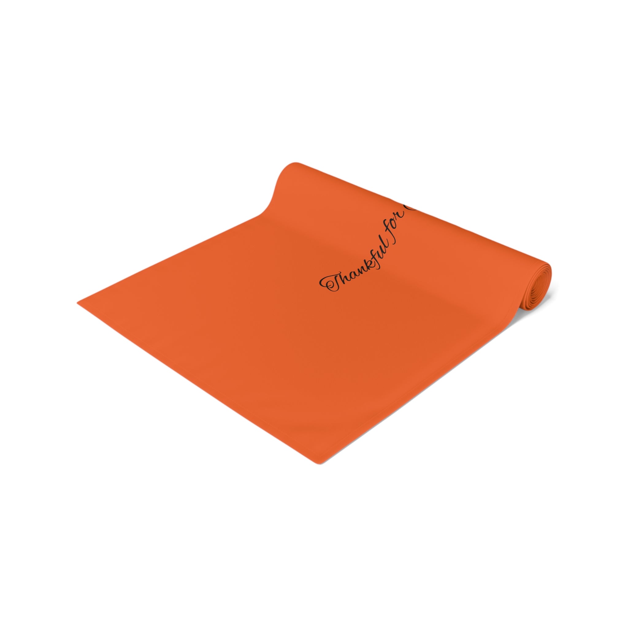 Orange table runner with 'Thankful for' text on a white background