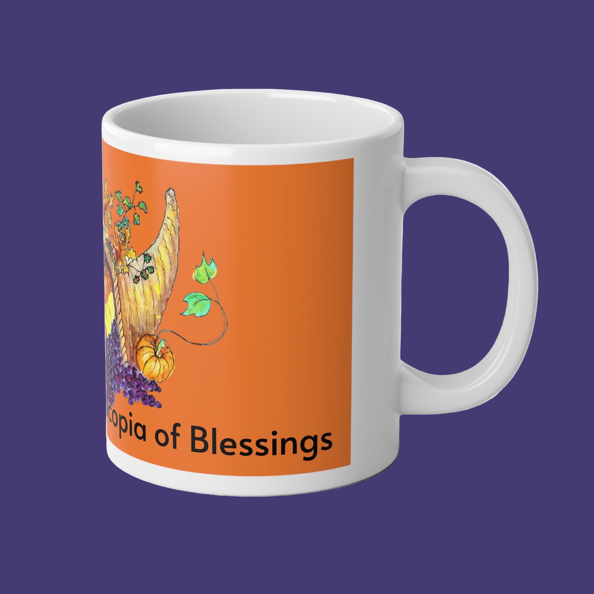 White mug with an orange design featuring a cornucopia and text on a purple background