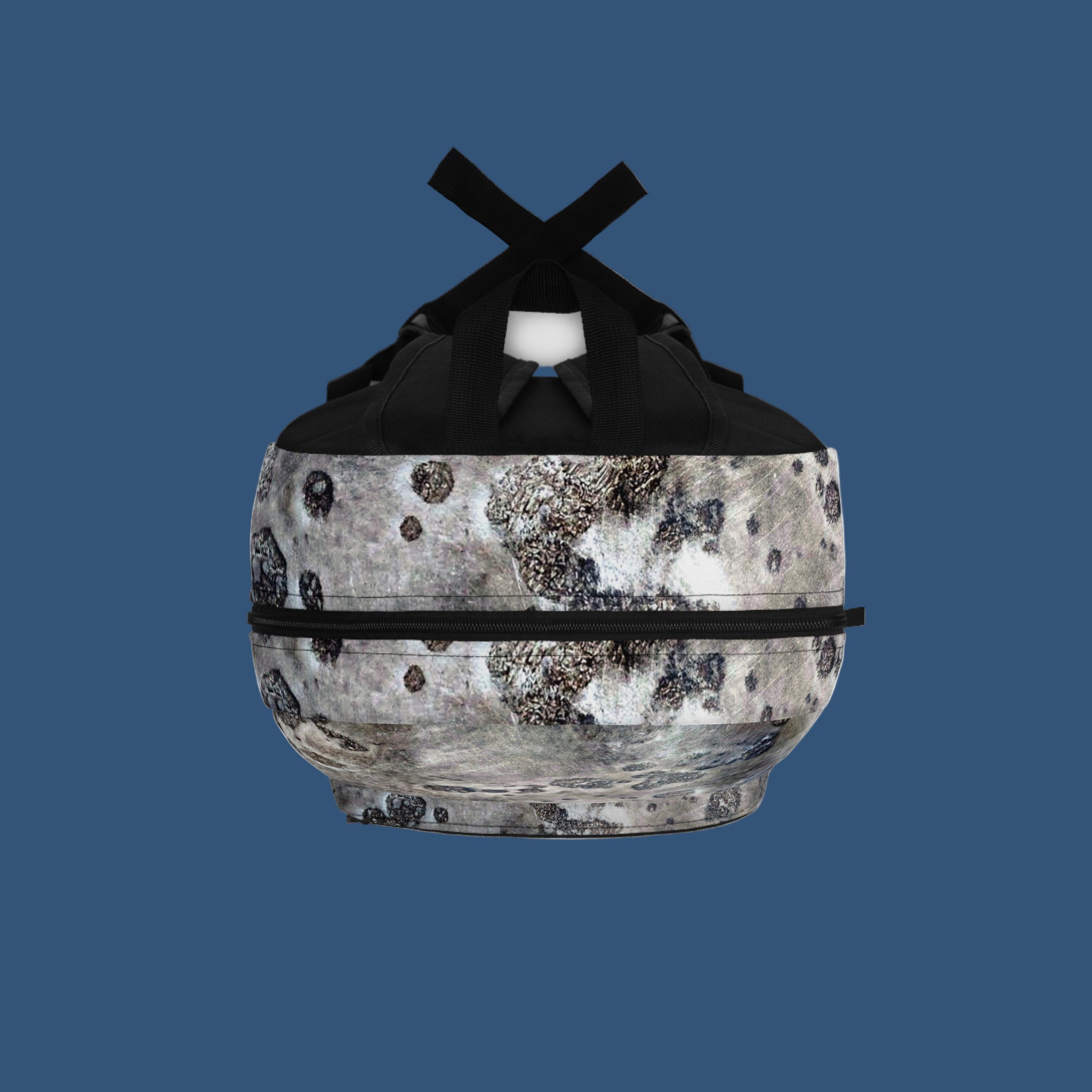Top of backpack with black straps on a blue background