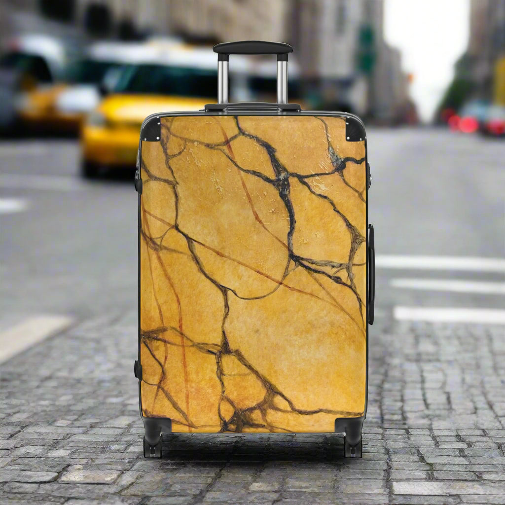 Marble-patterned suitcase waiting for a taxi in the city