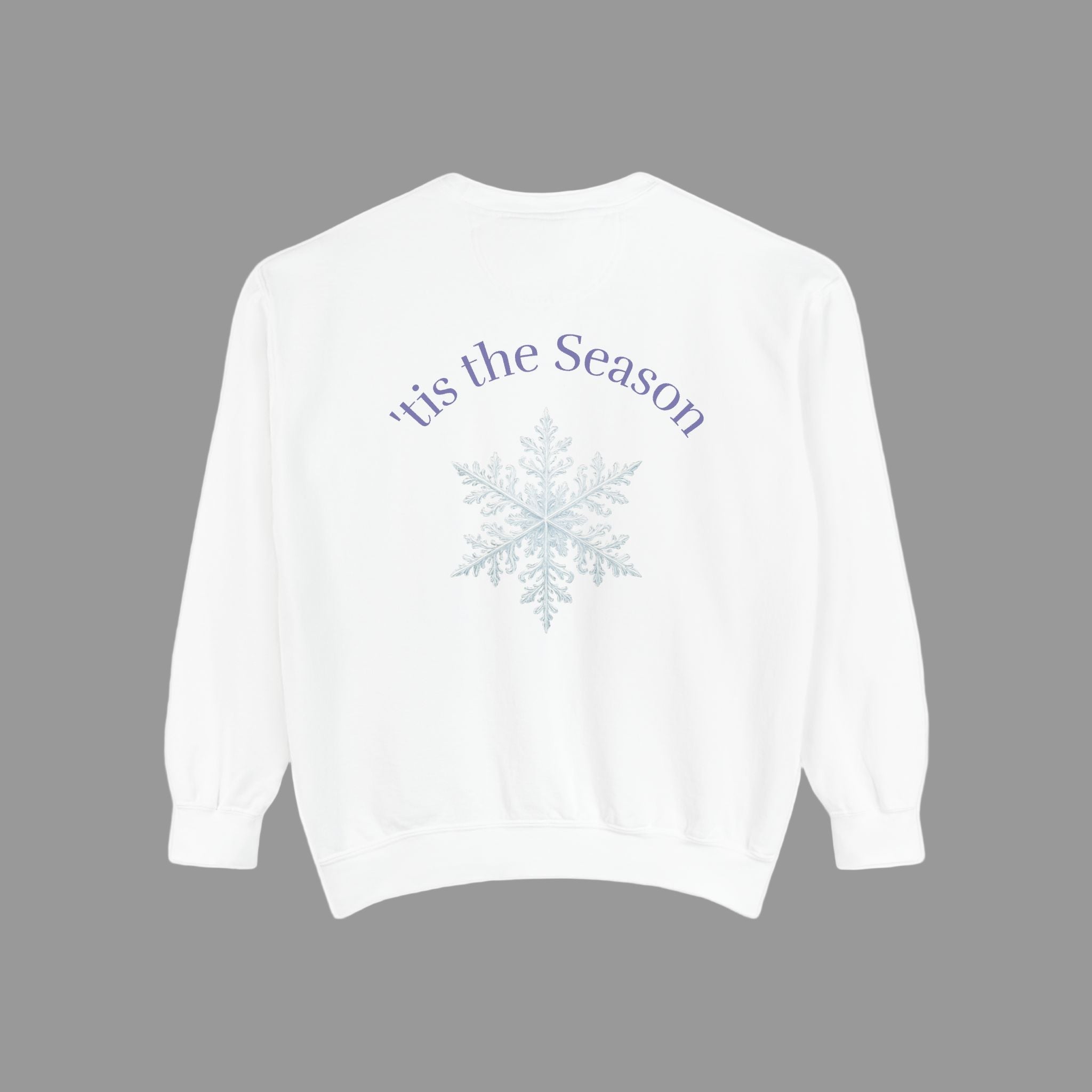 White sweatshirt with 'tis the Season and snowflake design on a light background