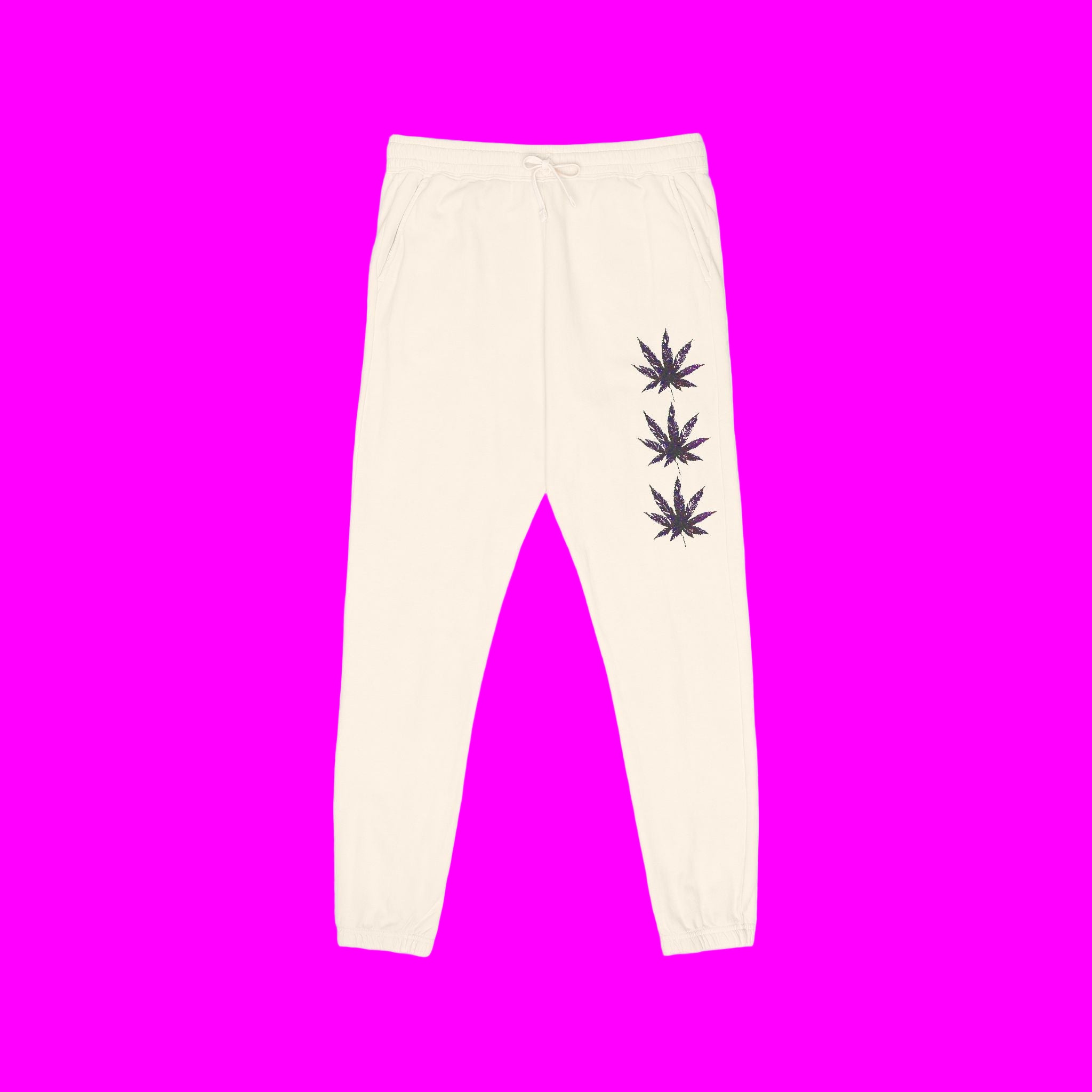 Beige sweatpants with purple leaf designs on a pink background