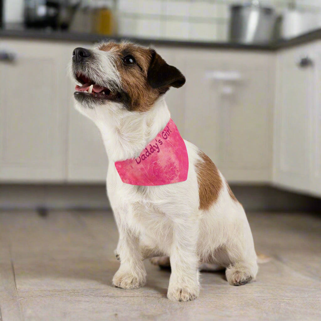 Small dog wearing a pink bandana with text in a kitchen background