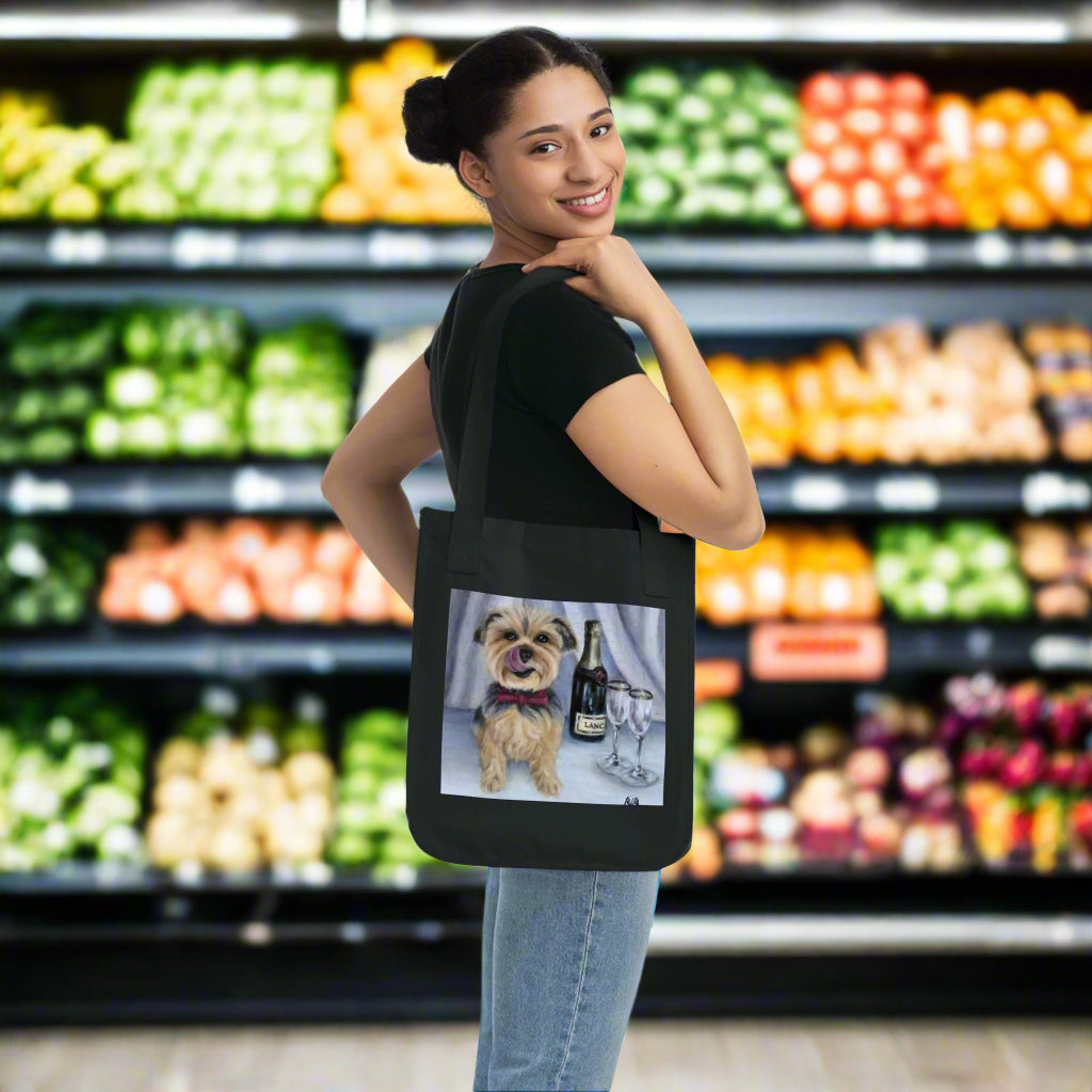Woman holding a black tote bag with a dog and wine design on a white background