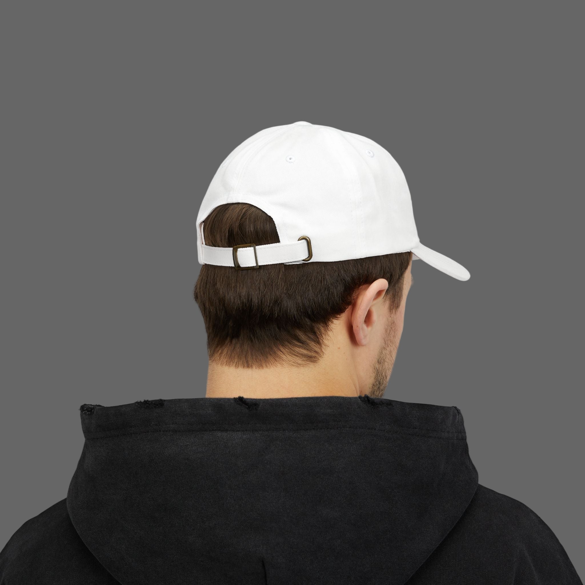 Person wearing a white cap and black hoodie from behind on a white background