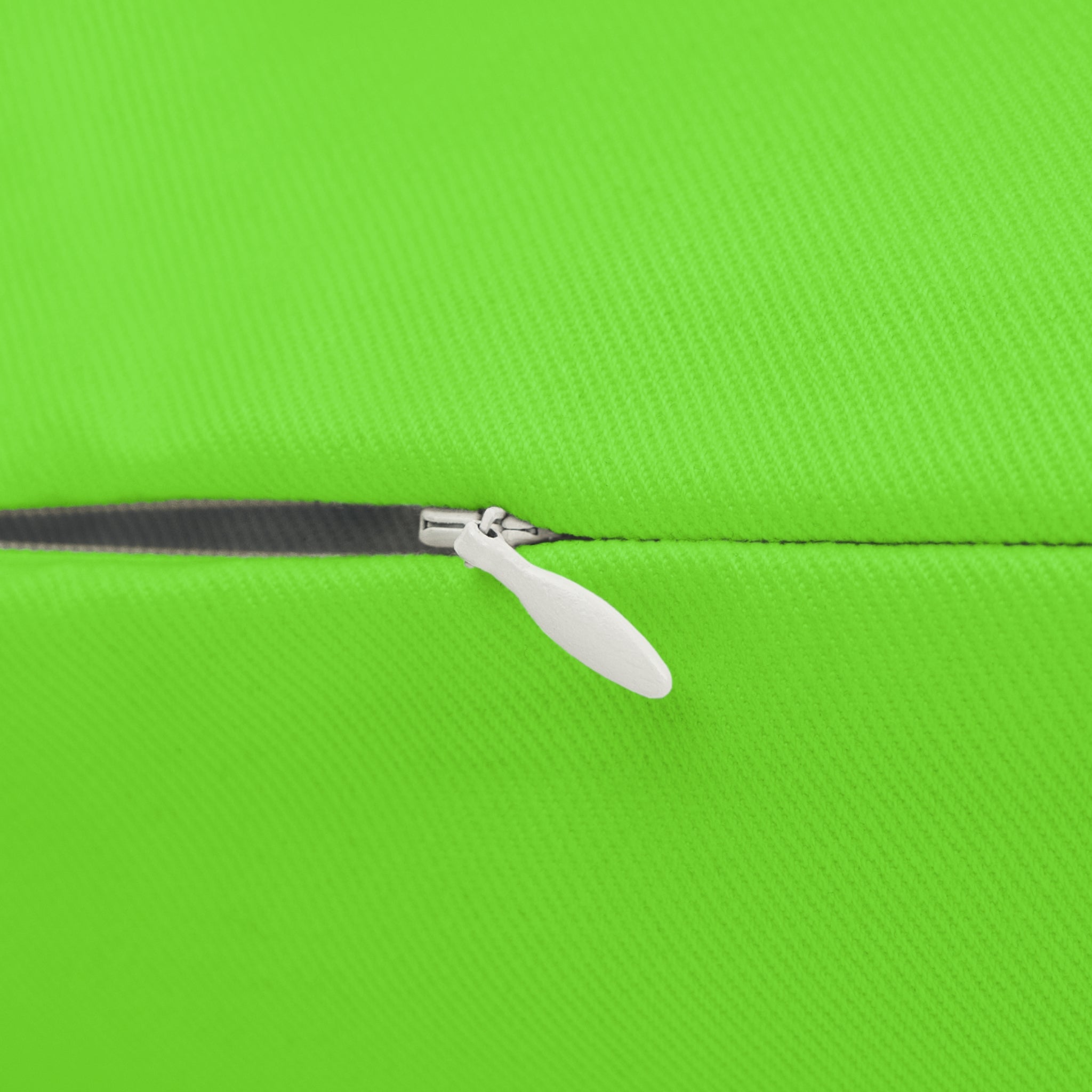 Close-up of a zipper on a green fabric  of lumbar pillow