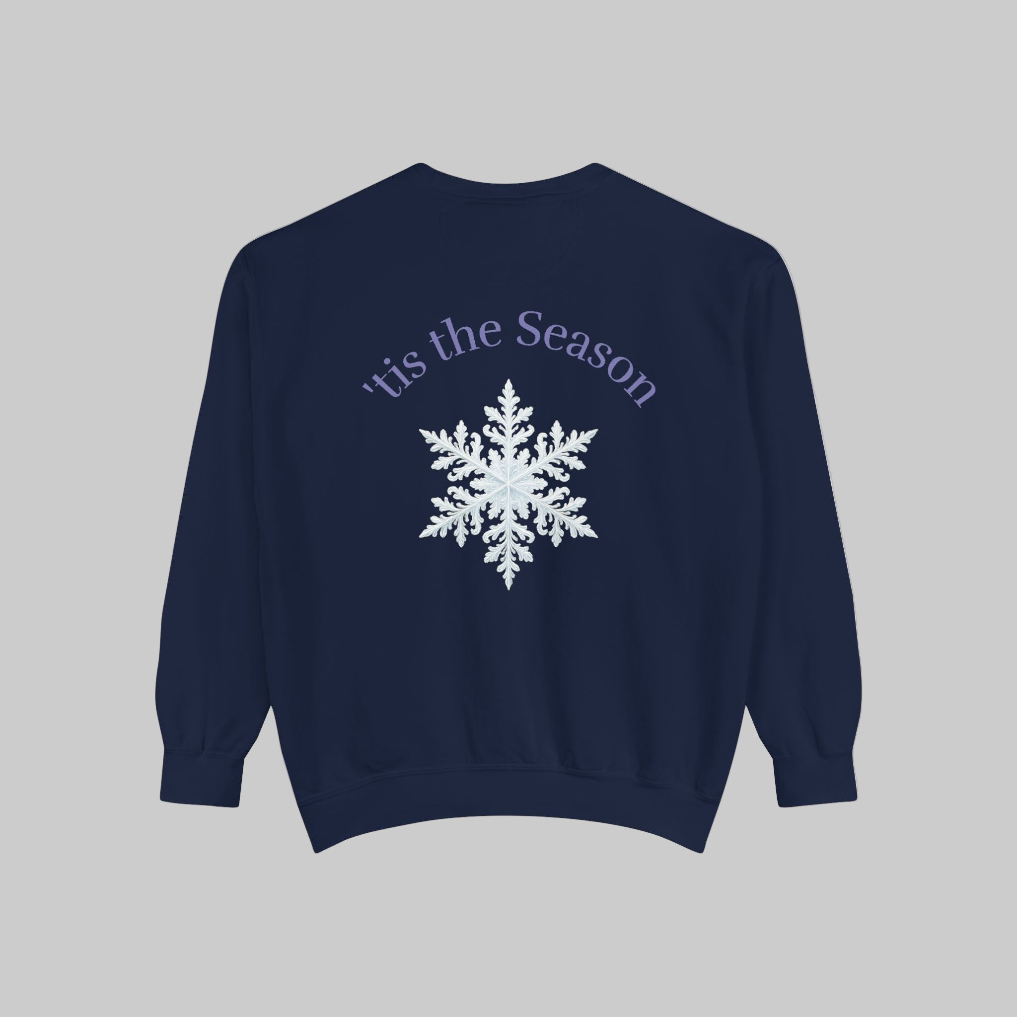Back view of Navy blue sweatshirt with white snowflake and text on a light background