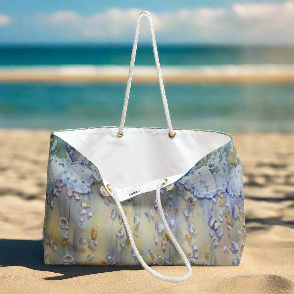 Beach painted tote bag with white handle on the beach