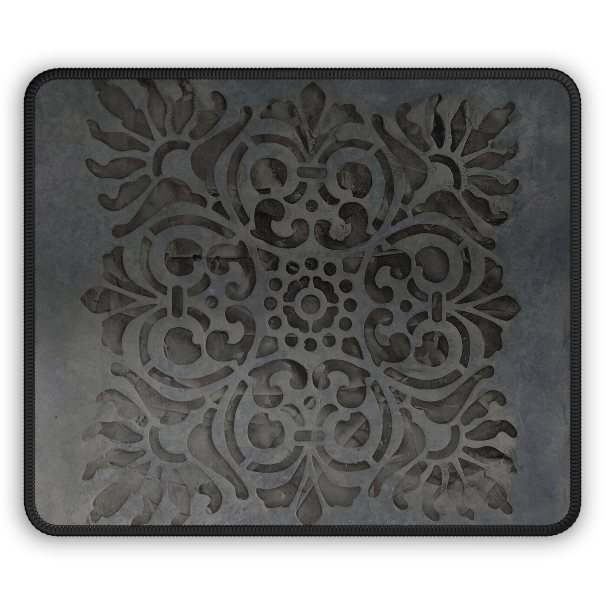 Decorative black mat with intricate patterns on a white background