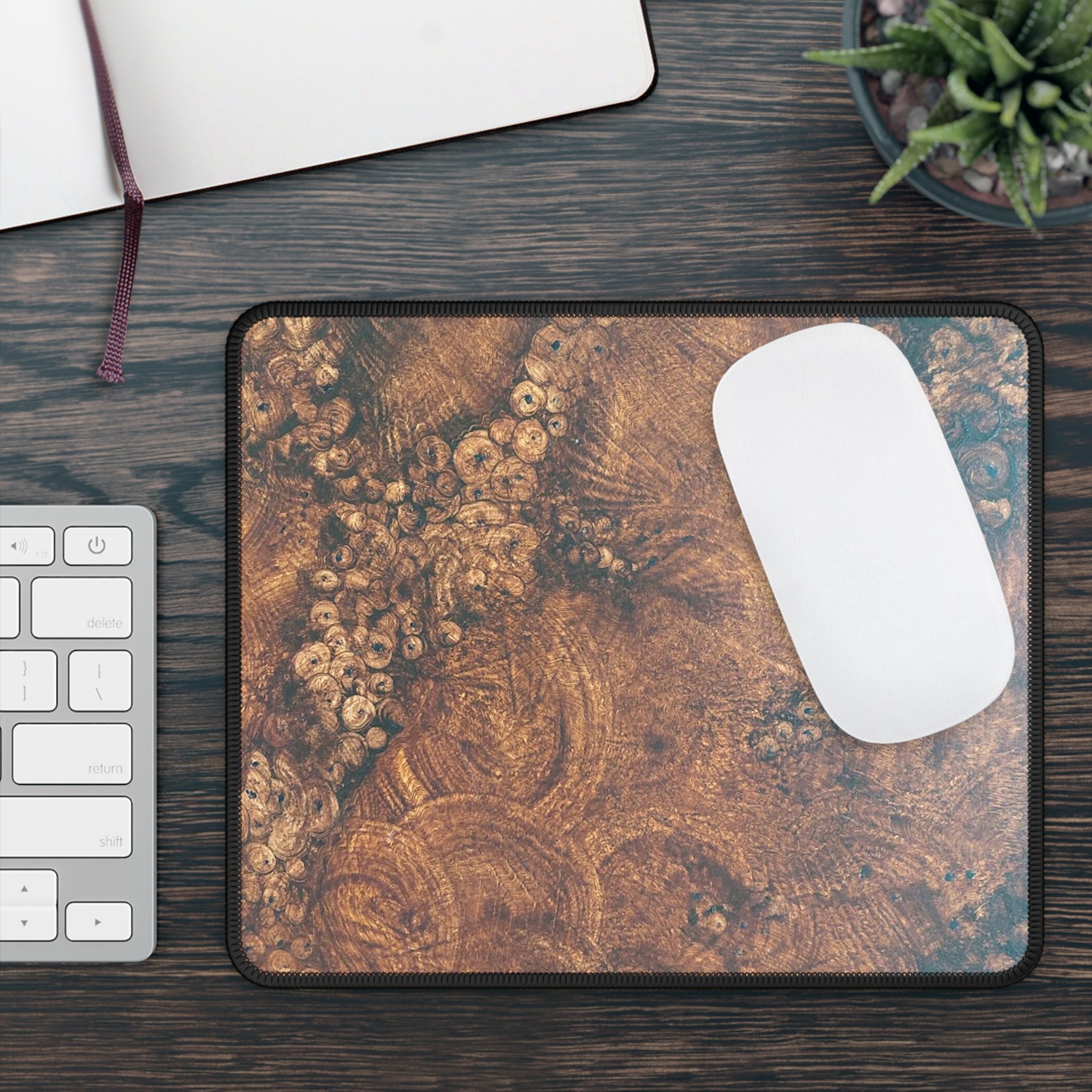 Mouse pad with artistic design on a desk with a keyboard and mouse.