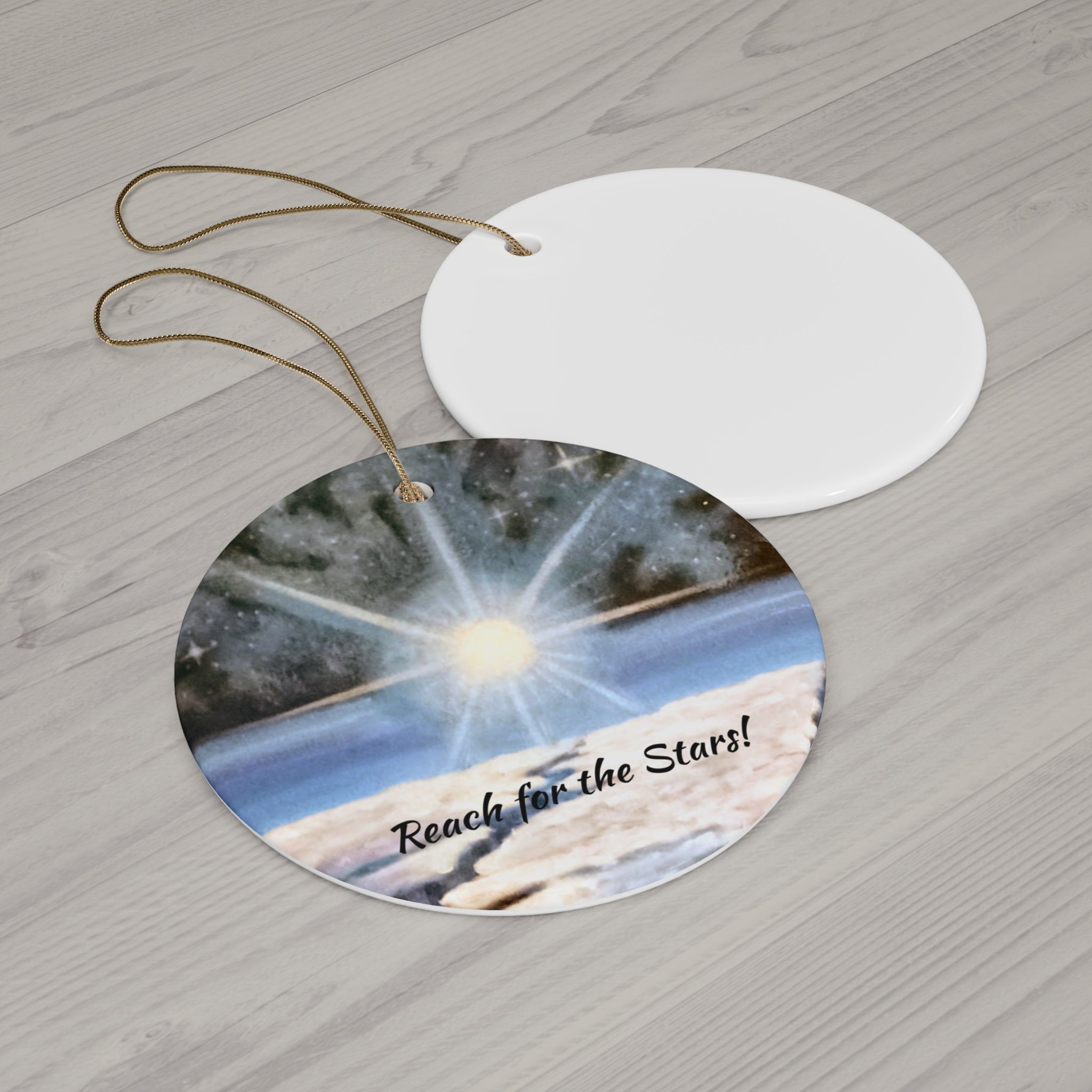 Circular ornament with starry night design and 'Reach for the Stars!' text on a wooden surface