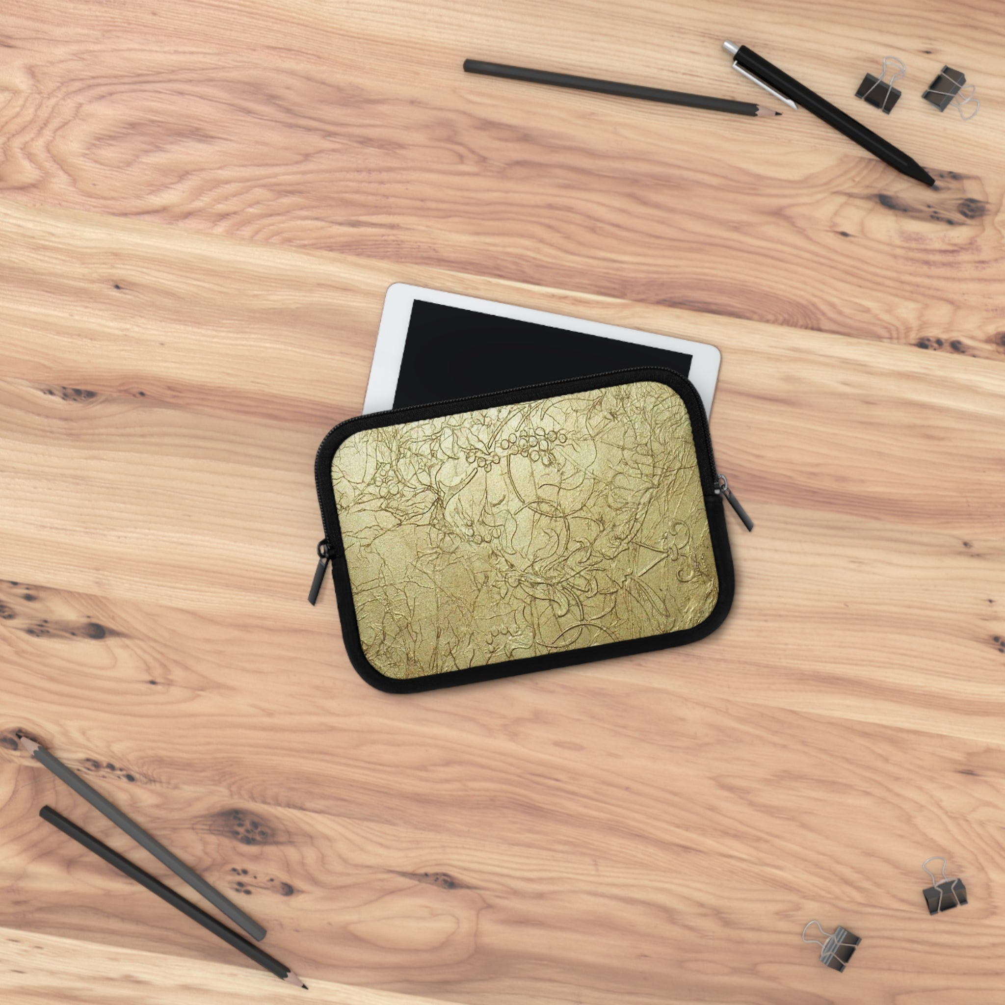 Gold Embossed themed tablet case on a wooden surface with pencils and erasers.