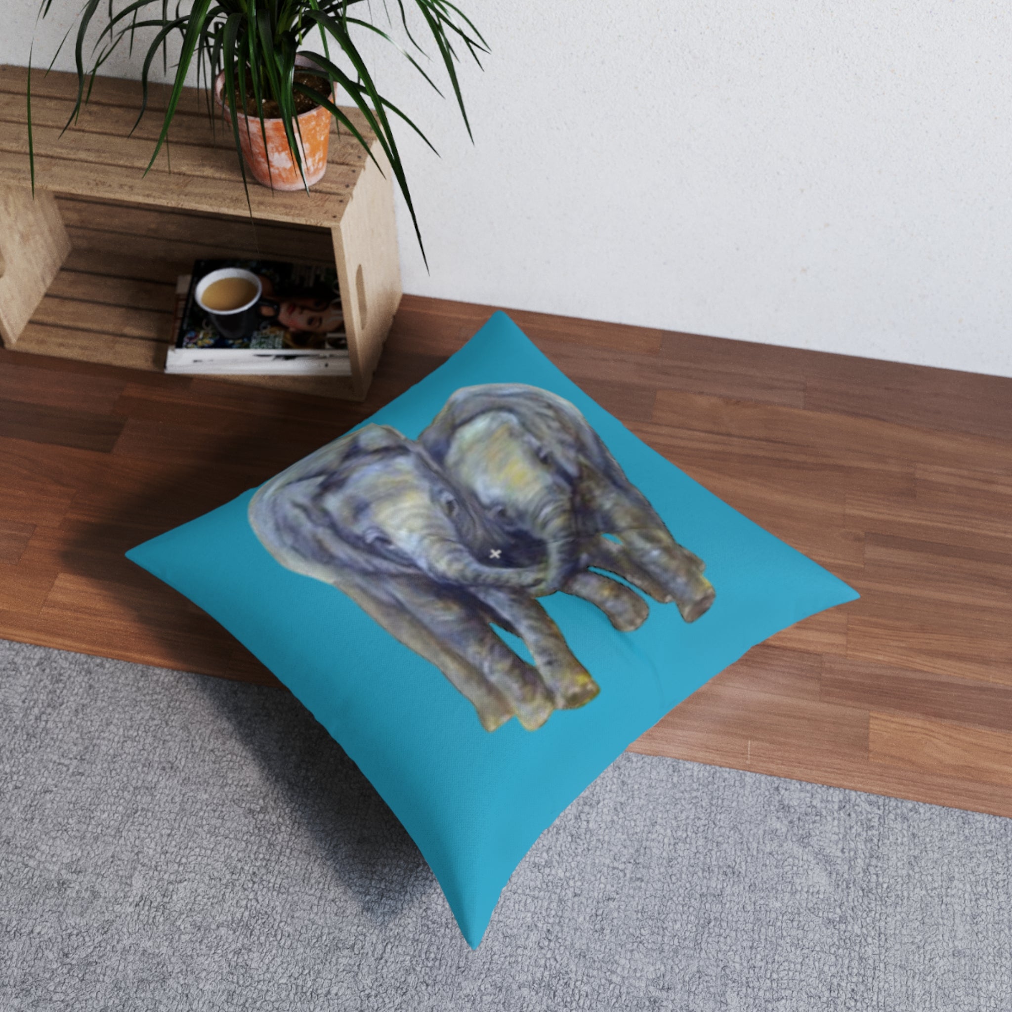 Floor pillow with an elephant design on a wooden floor.