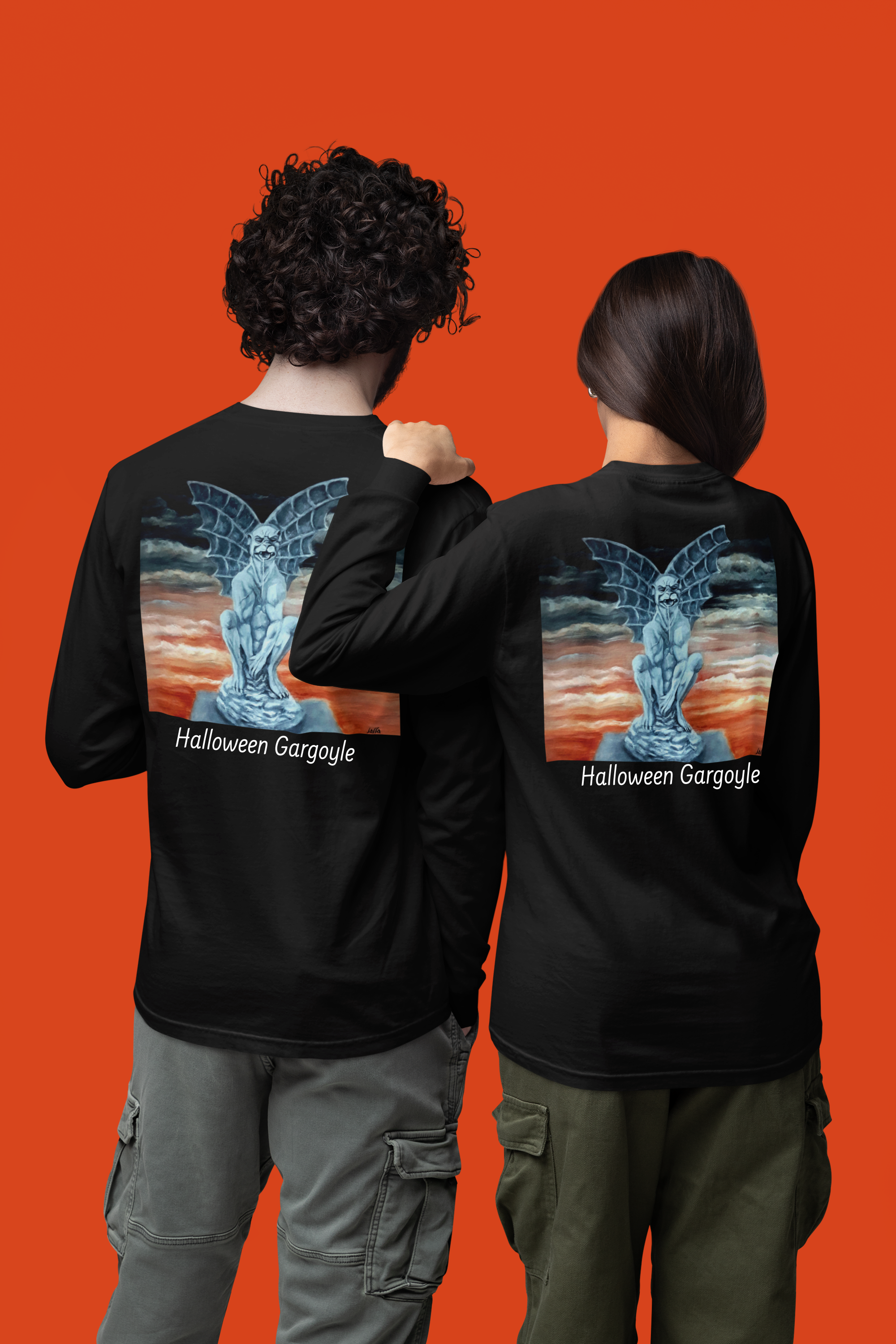 Two people wearing black long-sleeve shirts with a 'Halloween Gargoyle' design on the back against an orange background.