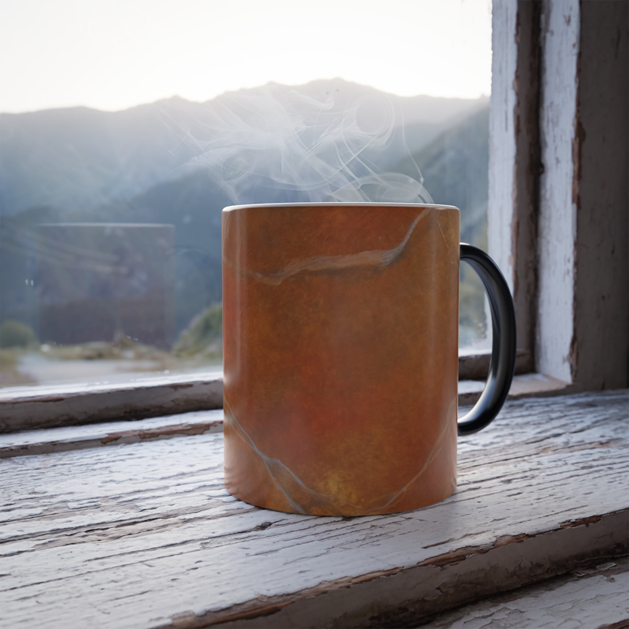 Steaming mug features red orange design by Studio Blitz on a windowsill with a mountain view