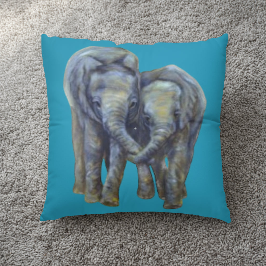Pillow with two elephants on a teal background