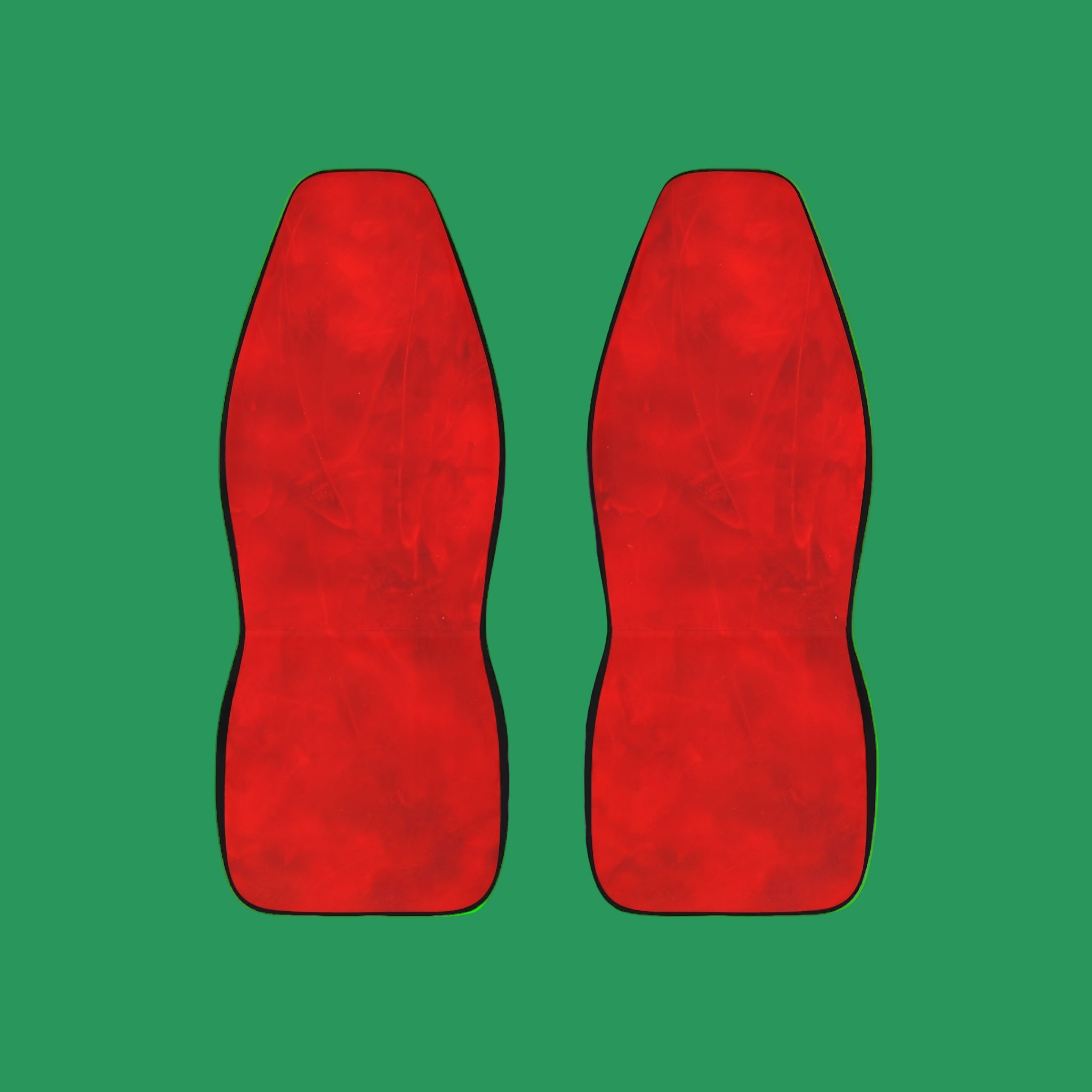 Pair of red car seat covers on a green background