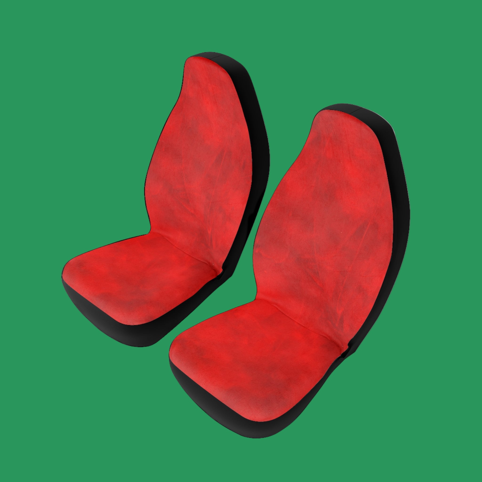 Pair of red car seat covers with black edges on a green background