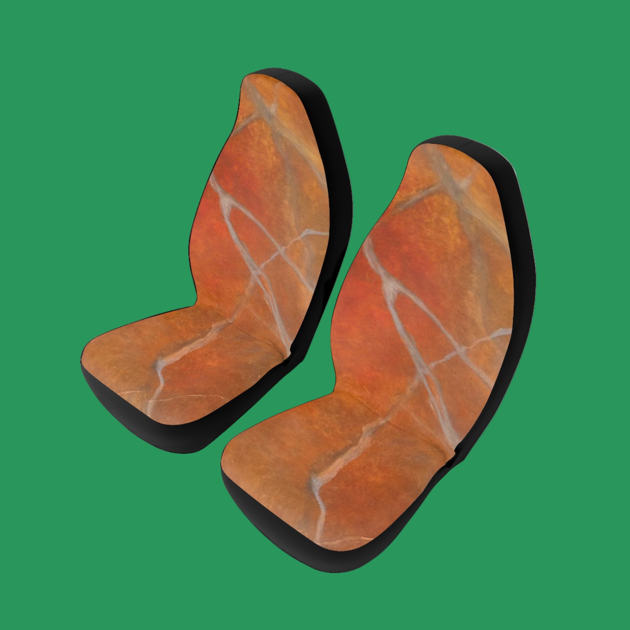 Pair of red/orange marble-patterned car seat covers on a green background