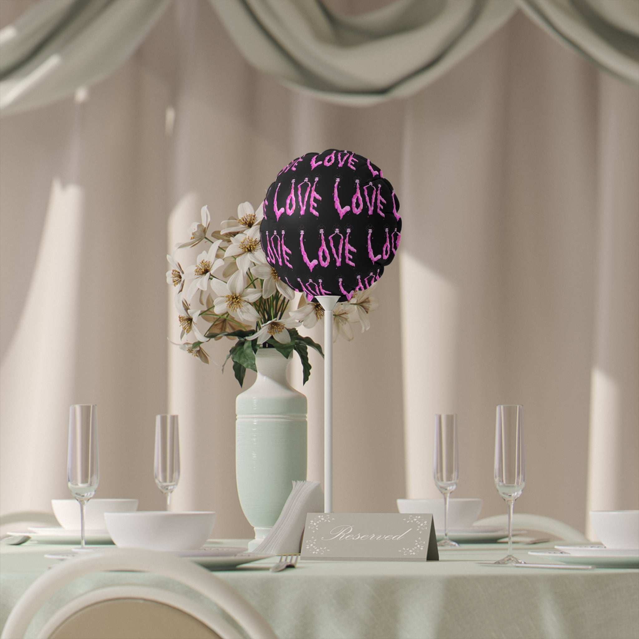 Decorative table setting with floral arrangement and 'LOVE' sign in a formal dining room.