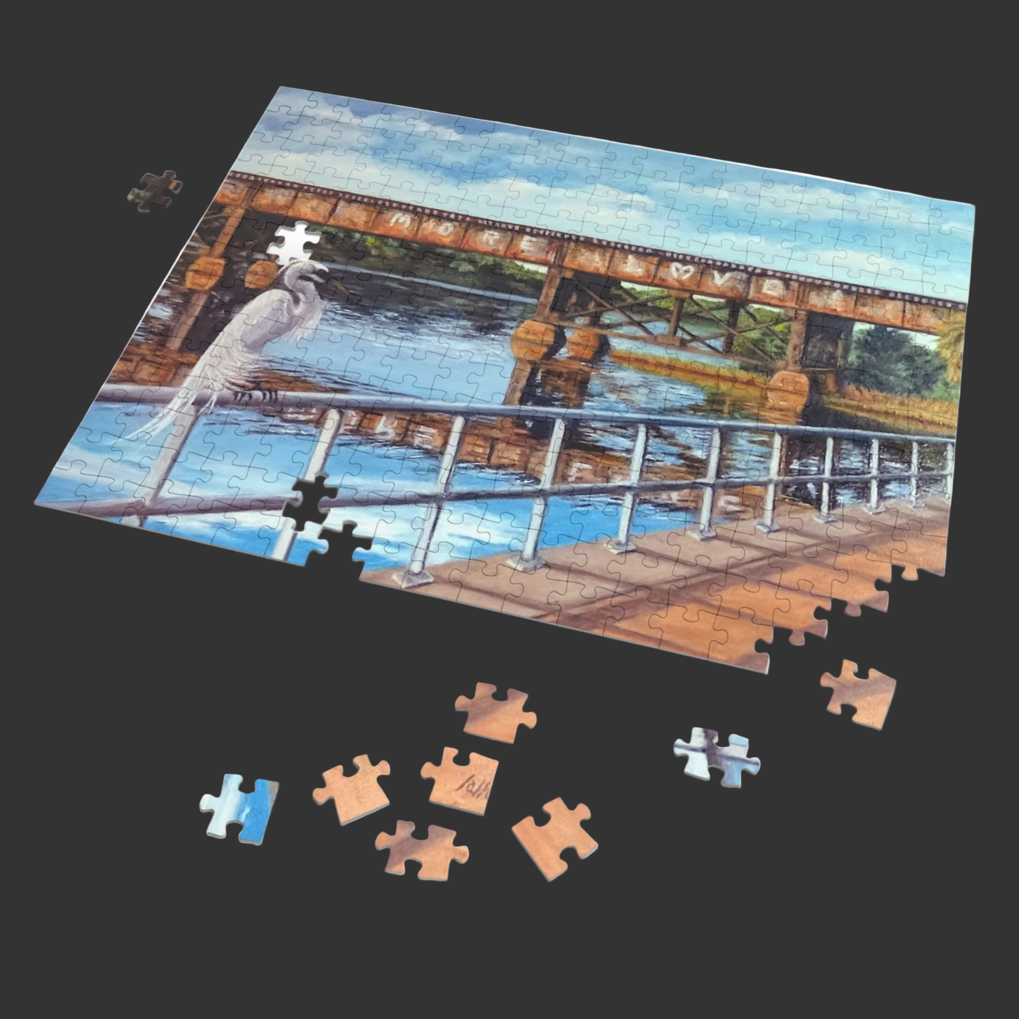 Jigsaw puzzle with a completed section showing a bridge and water, with missing pieces on a white background.