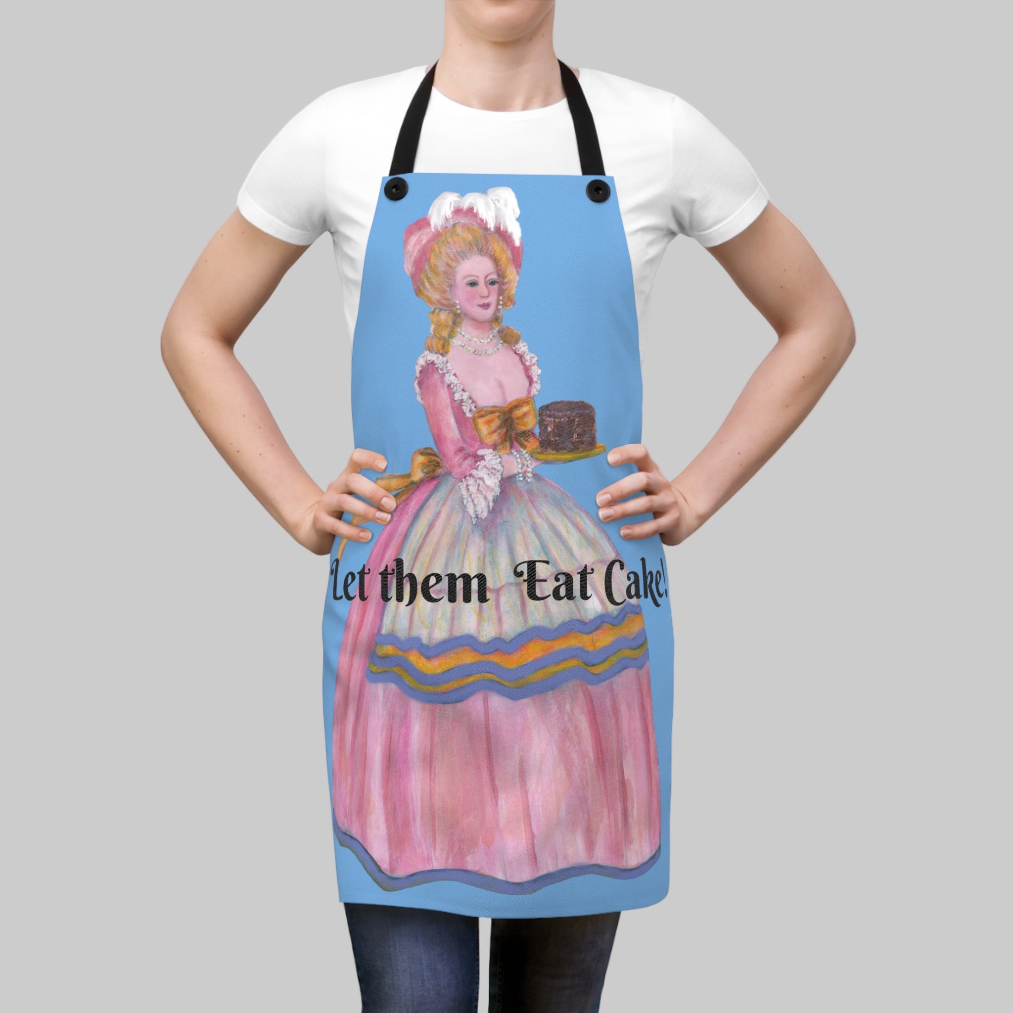 Person wearing a colorful apron with a design and text 'Let them Eat Cake' on a blue background