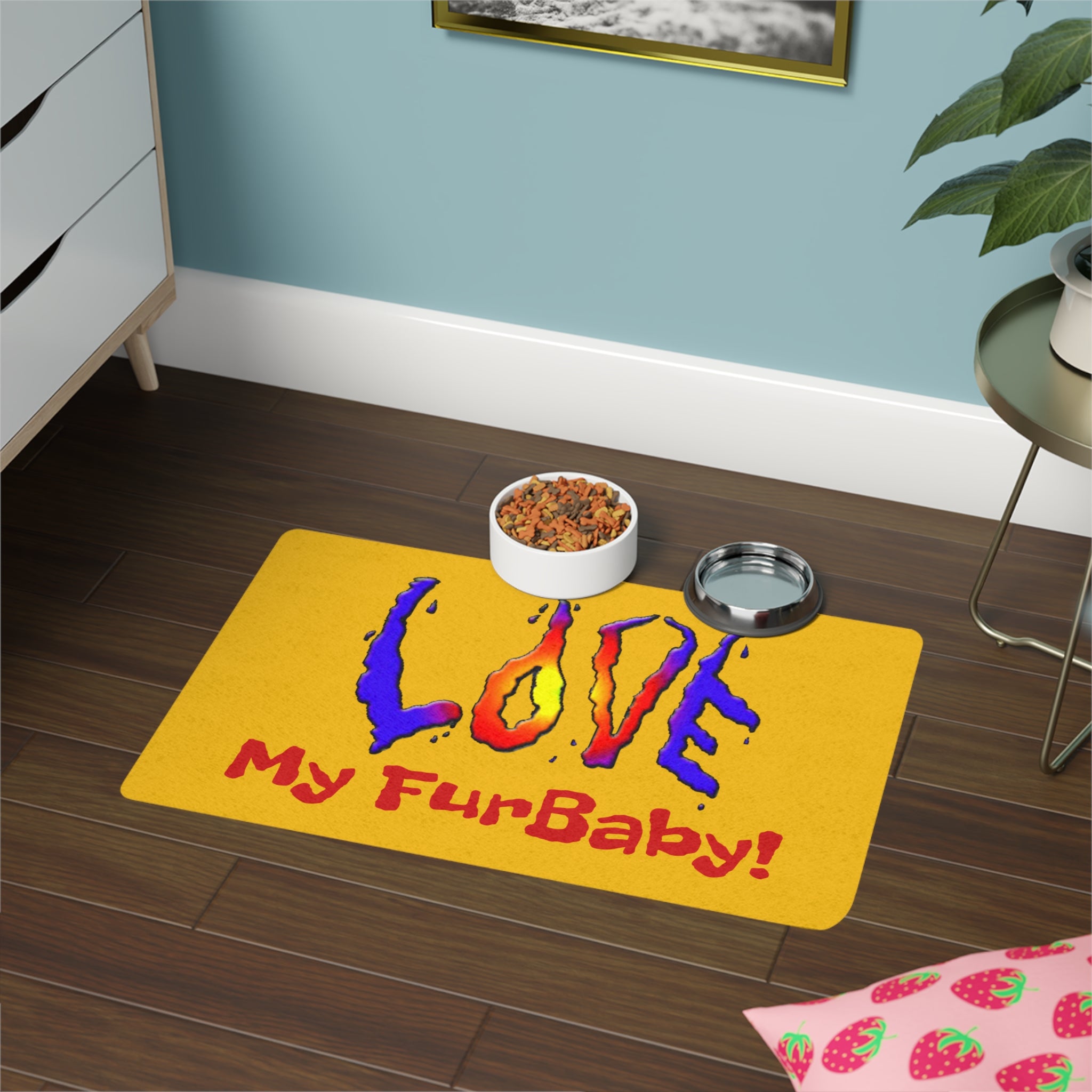 Yellow mat with 'Love My FurBaby!' text on a wooden floor with pet bowls.